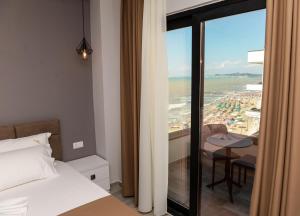 a bedroom with a bed and a view of the beach at Brilliant Hotel & SPA in Golem +154 photos