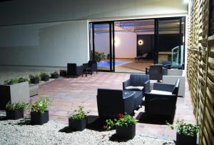 a patio with chairs and potted plants in a building at Boutique Hotel Ukus in Tešanj