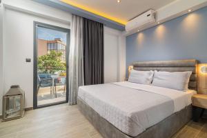 a bedroom with a large bed and a balcony at Oasis in Sarti
