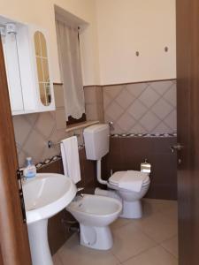 a bathroom with a toilet and a sink at Casa Vacanza "La Chiazza di Grutti" in Grotte +14 photos