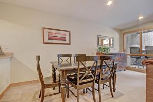 a dining room with a wooden table and chairs at Cm244 Copper Mtn Inn Condo in Copper Mountain