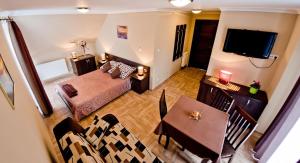 ein Wohnzimmer mit einem Esstisch und einem TV in der Unterkunft Heweliusz in Ustka