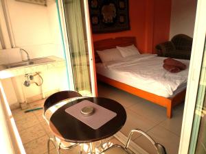 a bedroom with a bed and a desk at Jomtien Hostel in Jomtien Beach