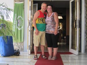 Un uomo e una donna in piedi davanti a una porta di Hotel Matilde a Marina di Massa