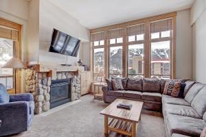 a living room with a couch and a fireplace at Tx304 Taylors Crossing Condo in Copper Mountain