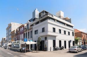 a white building on the side of a street at O Valentim in Matosinhos