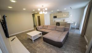 a living room with a couch and a table at Mieterlux 22 in Klaipėda