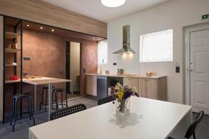 a kitchen with a white table with flowers on it at Pelagia Sea Side in Acharavi