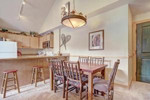 a kitchen and dining room with a table and chairs at Cs210 Copper Springs Condo in Copper Mountain