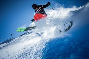 a person is skiing down a snow covered slope at Gästehaus Eder in Tröpolach