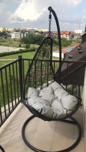 a hammock chair on a balcony with a view at Family & Business Elegant Apartments ul Warszawska - 2 Bedroom, Balcony, Parking in Kielce
