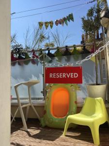 a pretend play house with a reserved sign and a chair at Little Western Spa Brighton Beach Apartments in Brighton & Hove
