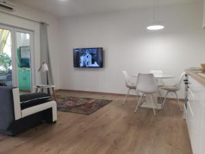 a living room with a table and white chairs at Centar Guest house in Makarska