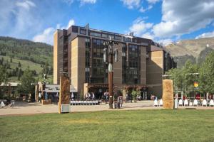 a large building with a grass field in front of it at MP518 Mountain Plaza Hotel Room in Copper Mountain