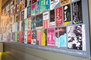 a wall filled with lots of albums at Star inn Peniche in Peniche