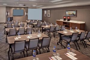 a conference room with tables and chairs and a screen at Hyatt Place Warwick/Providence Airport in Warwick +31 photos