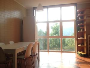 a kitchen with a table and chairs and a large window at Casa de Apeleiras in Marco de Canaveses