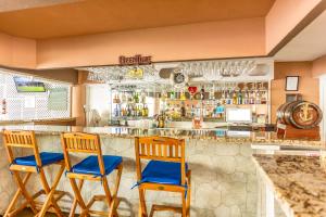 a bar with two chairs and a counter at Pirate's Inn in Bridgetown