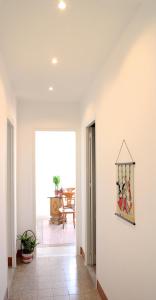 a hallway with a white wall with a picture on it at Beach House Mondello in Mondello