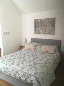 a bedroom with a bed with a comforter and pillows at The Old Stables in Taunton