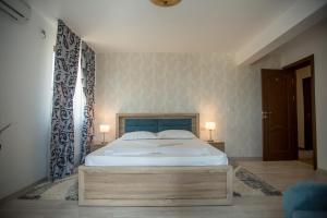 Postel nebo postele na pokoji v ubytování Andreea Residence Mamaia Nord