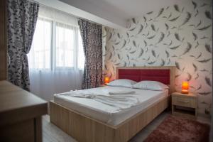 Postel nebo postele na pokoji v ubytování Andreea Residence Mamaia Nord