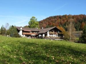 a large house on a hill in a field at Panoramahotel Karwendelhof in Wallgau