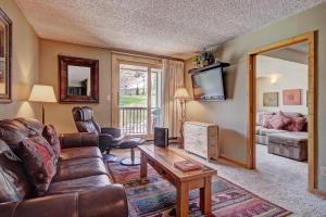 a living room with a couch and a table at Fp114 Foxpine Inn Condo in Copper Mountain