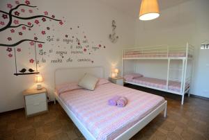 a bedroom with two beds and a tree mural at Le Palme 98 "Casa Vacanze" in Lido di Camaiore
