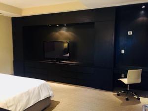 a hotel room with a bed and a television at Antaris Cintermex in Monterrey