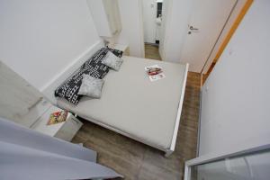 a white couch with pillows and a tie on it at Mobile homes Olive and Sea in Bibinje