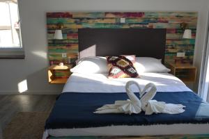 a bedroom with a bed with two white towels at Boho House in Pakoštane