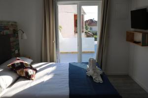 a bedroom with a bed with a large window at Boho House in Pakoštane