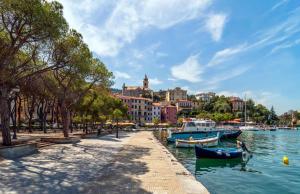 a group of boats in a body of water with buildings at L'ONDA 1 - Portovener-Fezzano in Fezzano