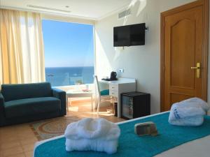 
a living room filled with furniture and a tv at Playasol Aquapark & Spa Hotel in Roquetas de Mar
