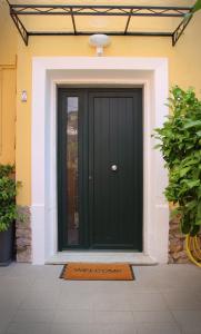 a black front door of a house with a mat at L'ONDA 3 Portovener-Fezzano in Fezzano