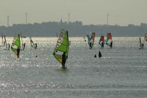 a group of people windsurfing in a body of water at Apartamenty Wakacyjne WICJAN in Chałupy