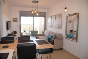 a living room with a table and a couch at Berger's Apartment in Eilat