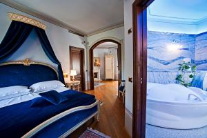a hotel room with a bed and a bathtub at Albergo La Lanterna in Sarteano