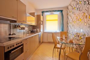 a kitchen with a table and a dining room at Apartament Nadmorski Sopot 1 in Sopot