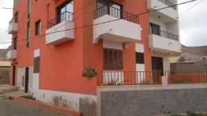 an orange building with balconies on a street at Palona´s House in Espargos