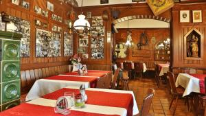 a restaurant with two tables with red tablecloths at Hotel Restaurant Mönchhof in Gaggenau