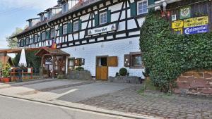 a building with ivy growing on the side of it at Hotel Restaurant Mönchhof in Gaggenau