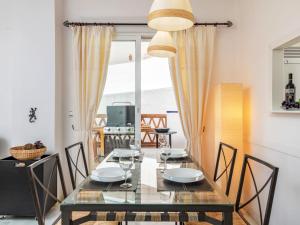 a dining room with a glass table and chairs at Apartment Island of Riviera Golf by Interhome in Sitio de Calahonda