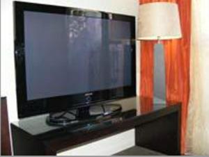 A television and/or entertainment centre at Terra Vive Suites & Apartments