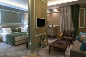 a hotel room with a bed and a couch at Mirart Hotel Boutique & SPA Yalova in Yalova