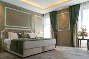 a bedroom with a large bed with a green blanket at Mirart Hotel Boutique & SPA Yalova in Yalova