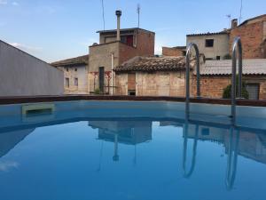a swimming pool with blue water in a building at Ruralfranxuli in Avellanes