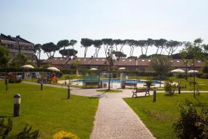 a park with a park bench and a playground at Alloggio Parco di Plinio in Infernetto