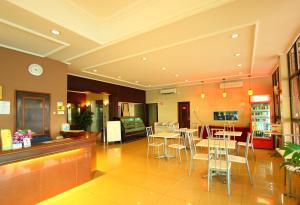 a dining area with tables and chairs in a restaurant at Grandpa Hotel in Port Dickson